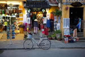 Woman in traditional conical hat on the market street of Hoi An